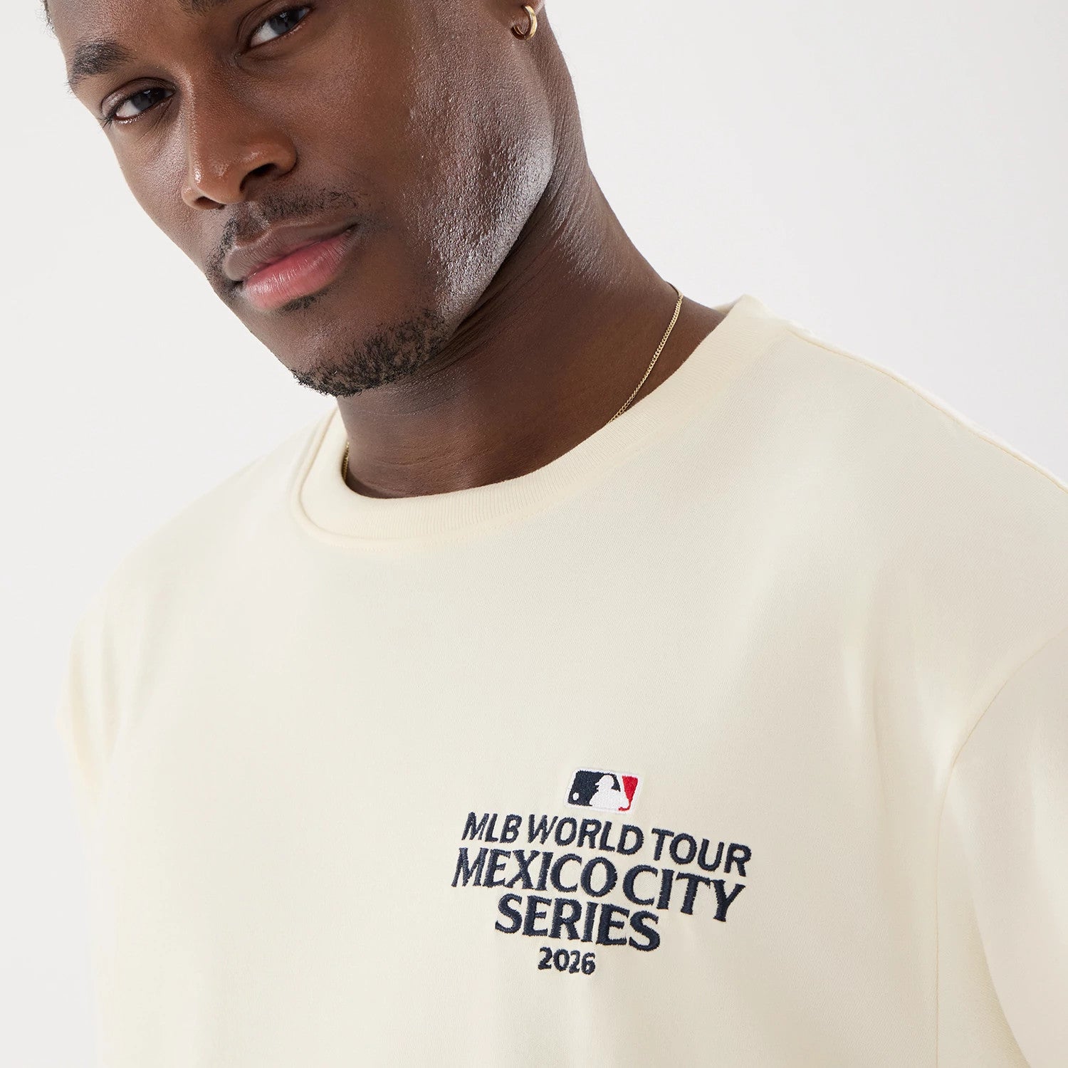 The model is wearing this MLB Mexico City Series 2026 Script Dueling Logo T-Shirt in Cream. 3