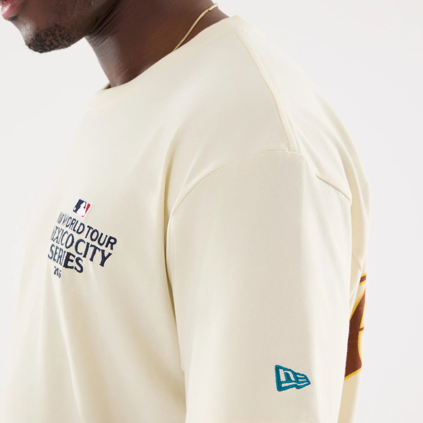 The model is wearing this MLB Mexico City Series 2026 Script Dueling Logo T-Shirt in Cream. 6