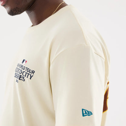 The model is wearing this MLB Mexico City Series 2026 Script Dueling Logo T-Shirt in Cream. 6