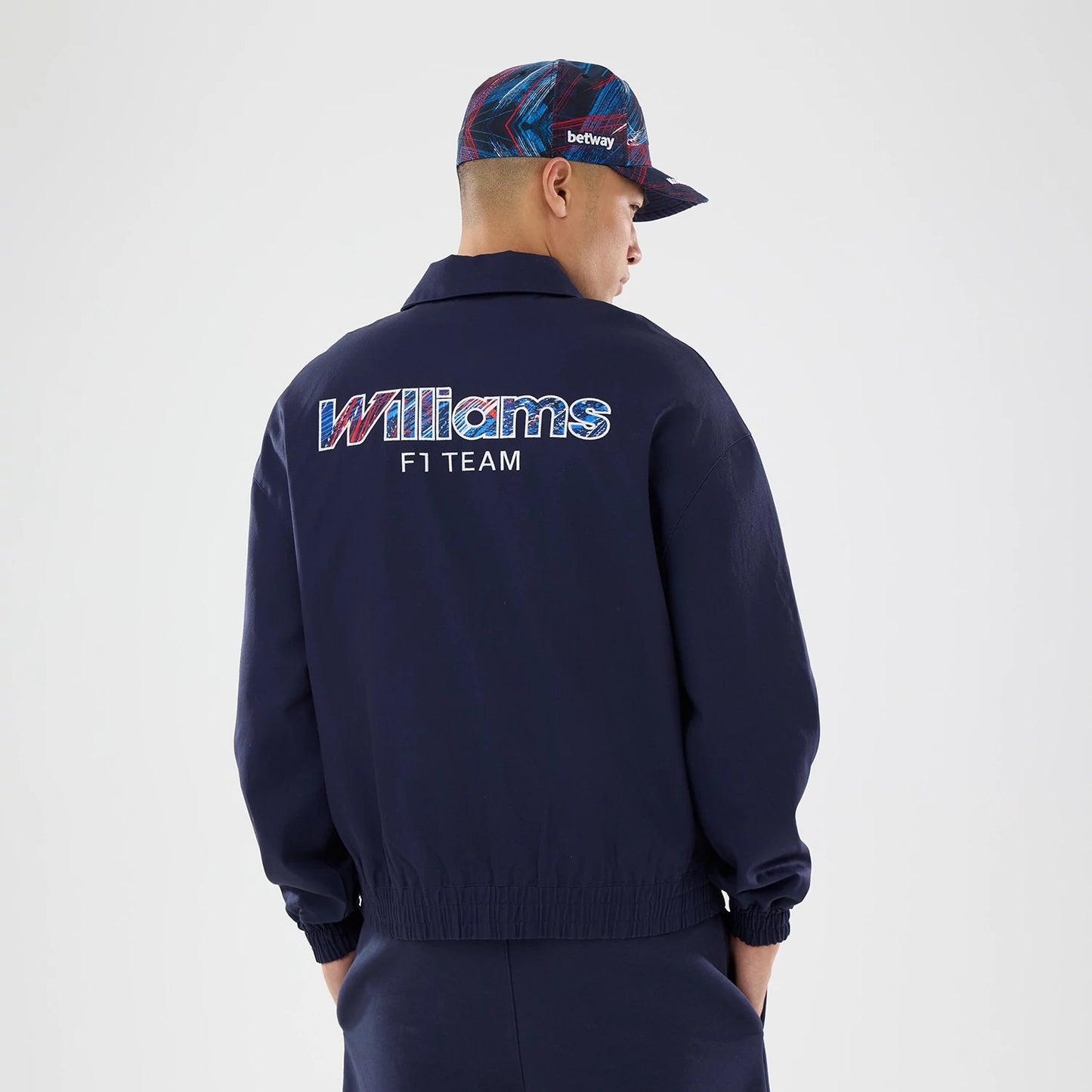 The model is wearing this Williams GB Race Special Collared Jacket in navy. 2