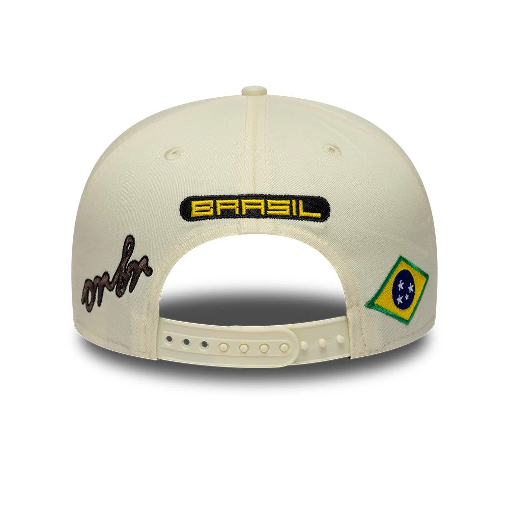 Red Bull Racing Brazil Race Special Team Cream New Era 9SEVENTY Stretch Snap Adjustable Cap, rear view showing a yellow and black BRAZIL logo on the middle back, with a script logo on the left and a Brazilian flag patch on the right.
