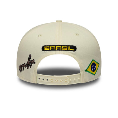 Red Bull Racing Brazil Race Special Team Cream New Era 9SEVENTY Stretch Snap Adjustable Cap, rear view showing a yellow and black BRAZIL logo on the middle back, with a script logo on the left and a Brazilian flag patch on the right.