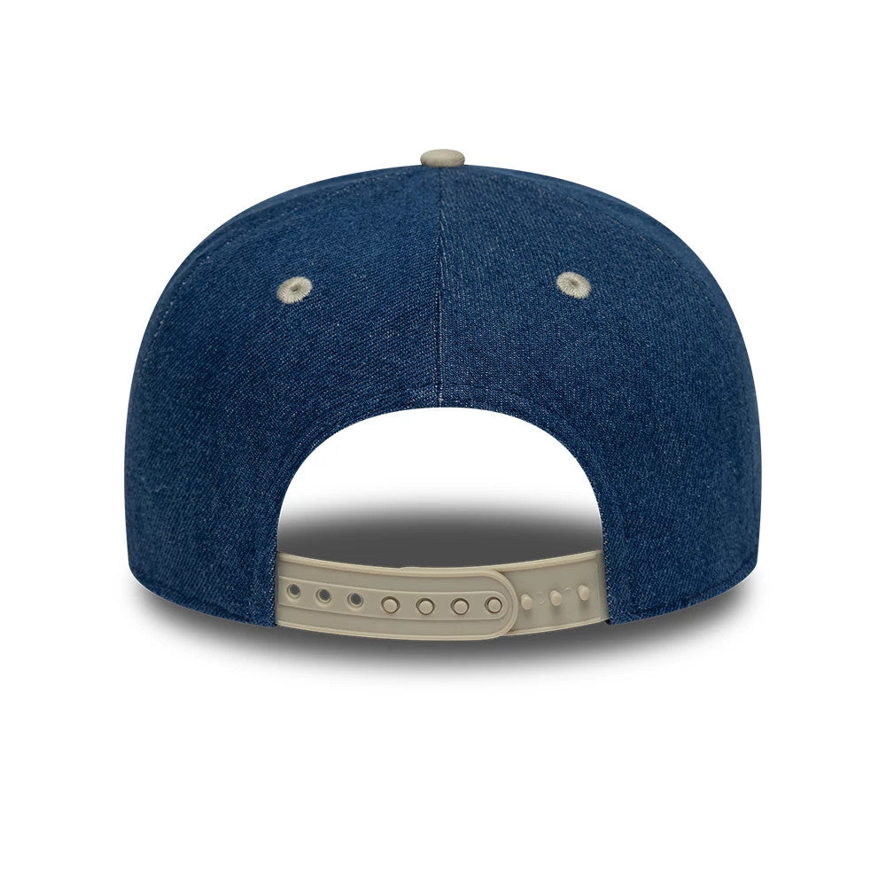 Alpine Racing Austin Race Special Denim Navy New Era 9SEVENTY Stretch Snap Adjustable Cap, rear view showing the undetailed centre back panel, two light embroidered eyelets, and a beige adjustable snap closure.