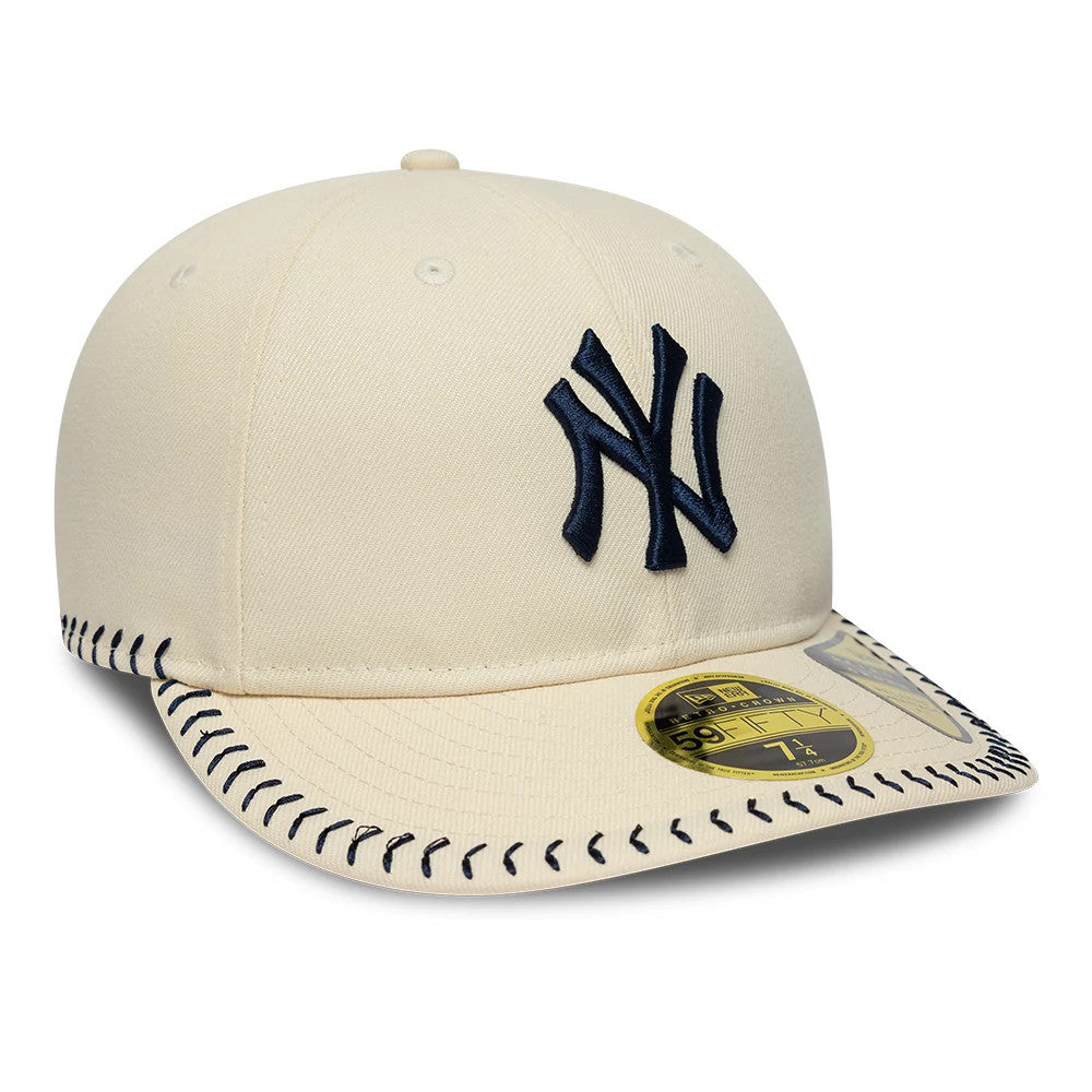 New York Yankees MLB Baseball Stitch Cream Retro Crown New Era 59FIFTY Fitted Cap, three-quarter view showing a raised navy NY logo on the cream front panel, black stitch along the visor edge, and a gold 59FIFTY size sticker on the curved visor.