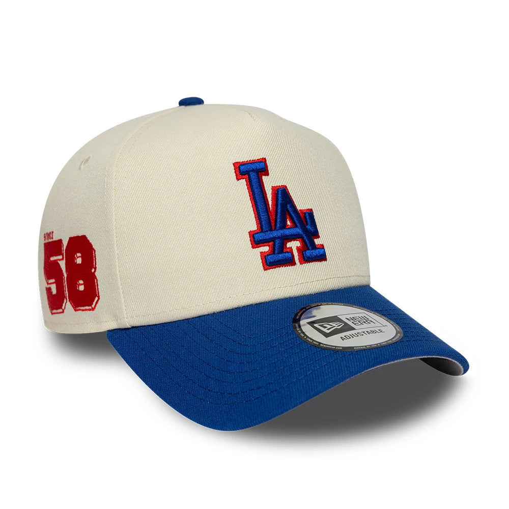 Pictured is this MLB Side Hit LA Dodgers 9FORTY E-Frame cap in Cream. 1
