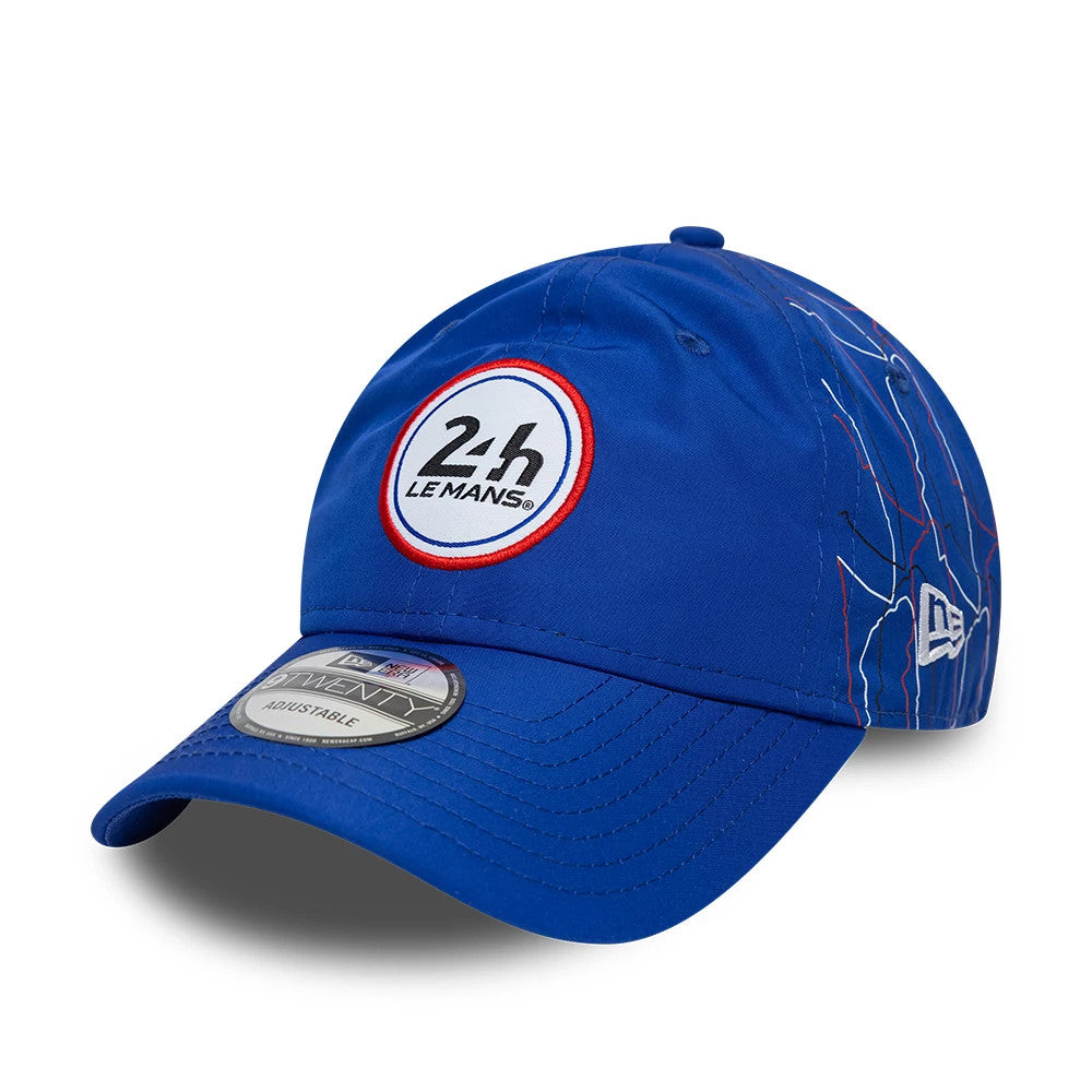 24HR Le Mans Track Blue New Era 9TWENTY Adjustable Cap, three-quarter view showing the embroidered 24h Le Mans logo on the blue front panel, with a curved visor featuring a 9TWENTY size sticker and white New Era flag on the left side.