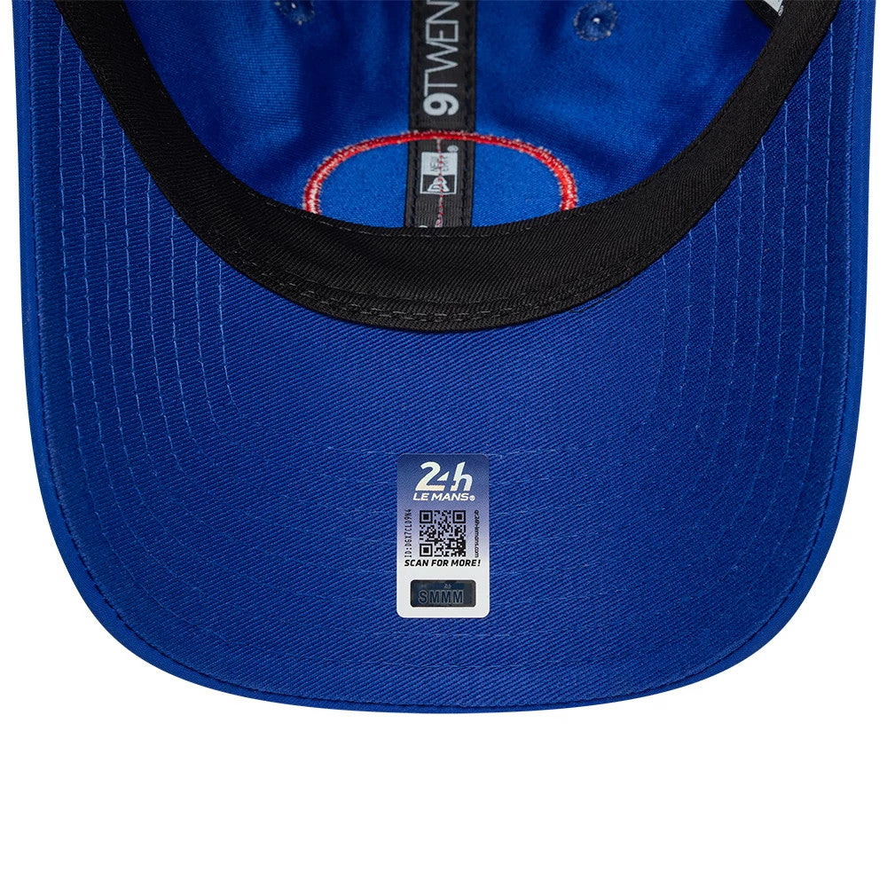 24HR Le Mans Track Blue New Era 9TWENTY Adjustable Cap, inside view showing a black sweatband, red-lined seam tape with white 9TWENTY branding, and a silver-grey 24H Le Mans sticker centrally placed on the blue undervisor.