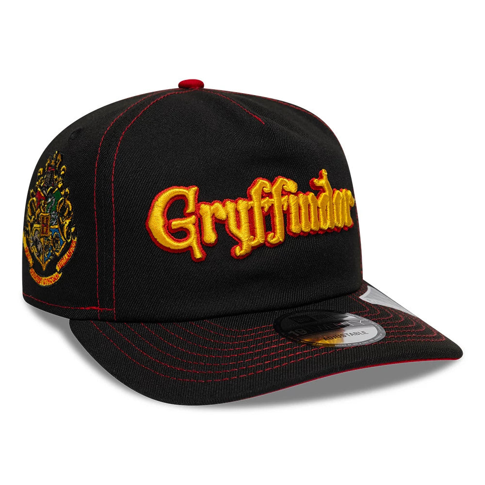 Harry Potter Gryffindor Black New Era 19TWENTY Adjustable Cap, three-quarter view showing the yellow and red embroidered Gryffindor lettering on the front panel, red top button, a decorative crest on the side.