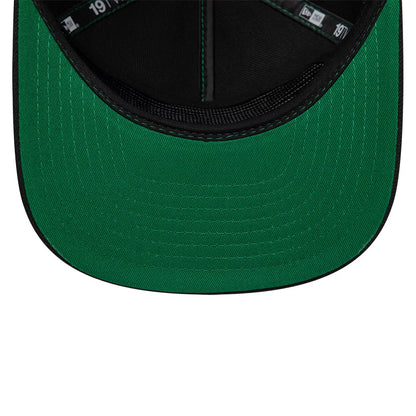 Harry Potter Slytherin Black New Era 19TWENTY Adjustable Cap, inside view showing the green undervisor with black stitching, black internal seams with green taping, and part of the 19TWENTY tag inside the black crown.