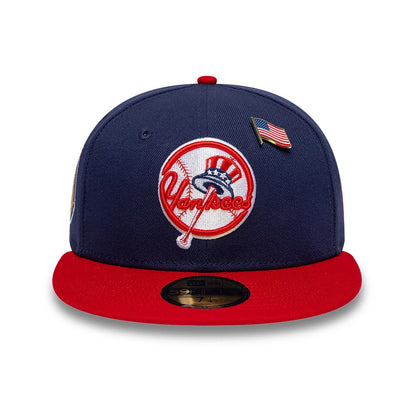 New York Yankees MLB Sister Cities Blue & Red New Era 59FIFTY Fitted Cap, front view showing the white and red embroidered Yankees logo centred on a blue crown, with an American flag pin, red visor and gold 59FIFTY size sticker.