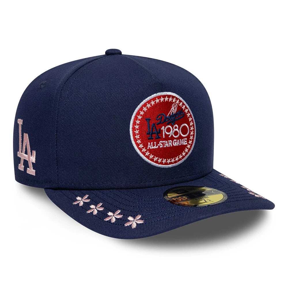 LA Dodgers MLB All Star Game Navy New Era 59FIFTY A-Frame Fitted Cap, three-quarter view showing a red and white embroidered LA 1980 All Star Game patch on the front panel, pink LA logo on the side and floral details on the visor.