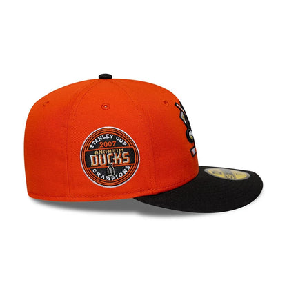 Pictured is this NHL Champions Anaheim Ducks 59FIFTY Fitted cap in orange & black. 6