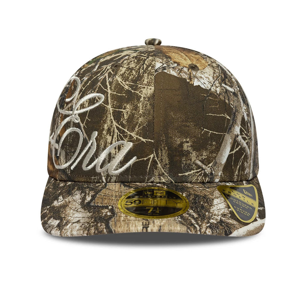 New Era Side Script Realtree Camo Low Profile 59FIFTY Fitted Cap, front view showing white embroidered script lettering on the right front panel, a camouflage pattern over the entire structured crown.
