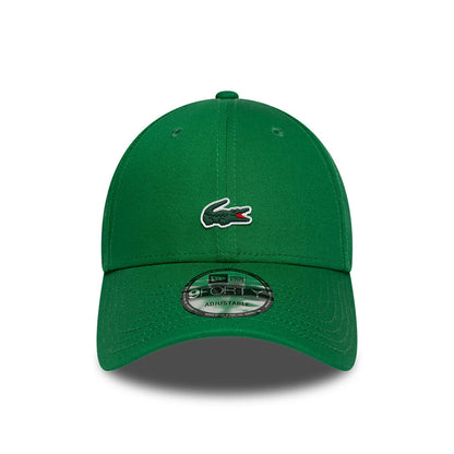 Lacoste X New Era Green 9FORTY Adjustable Cap, front view showing the Lacoste crocodile logo in raised embroidery on the centre of the green crown, with a green curved visor featuring the 9FORTY size sticker on top.