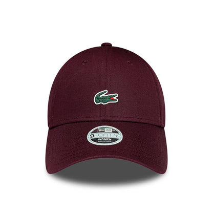 Womens Lacoste X New Era Dark Purple 9FORTY Adjustable Cap, front view showing the raised green Lacoste crocodile logo on the dark purple structured crown, with a curved visor and a 9FORTY size sticker on the centre.
