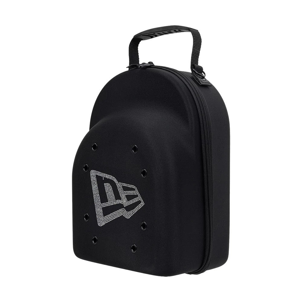 New Era Rhinestone Black 6Pk 59FIFTY Cap Carrier, three-quarter view highlighting the structured black shell with a zip closure along the edge, a carry handle on top, multiple eyelets on the surface, and a rhinestone-embellished New Era logo.