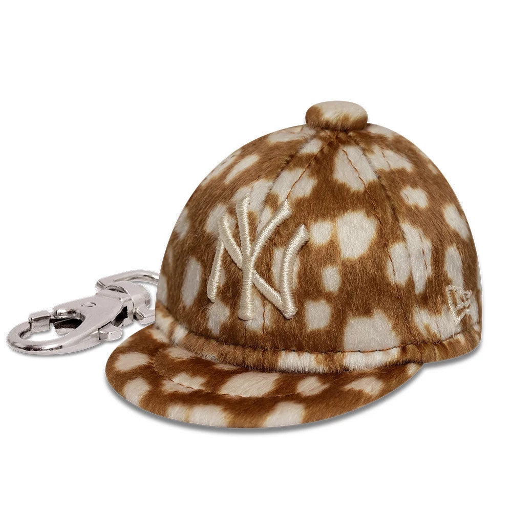 New Era New York Yankees MLB Animal Mini Cap Light Brown Key Chain, three-quarter view showing a plush light brown and white spotted design with raised embroidered NY logo on the front, featuring a New Era flag logo on the left side.