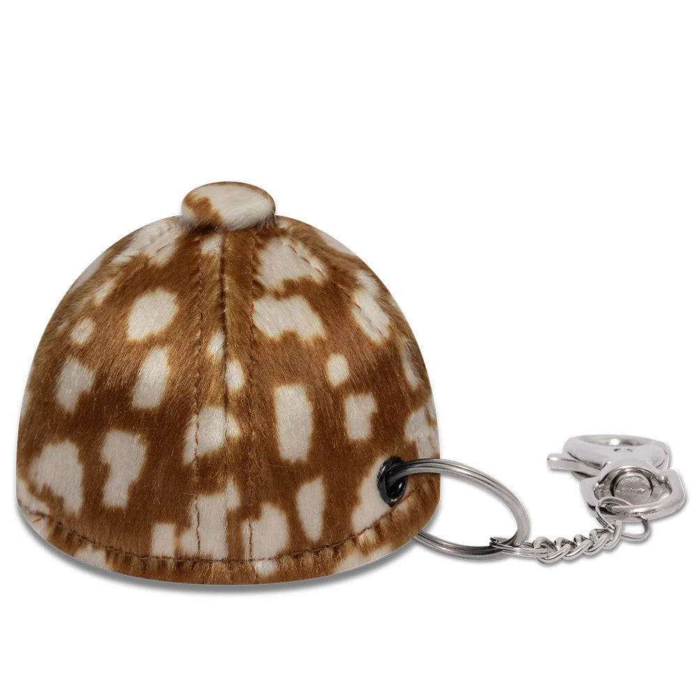 New Era MLB Animal Mini Cap Cow Print Key Chain, three-quarter view showing a plush cap design with a brown and white cow print pattern, a top button, and a key ring with a lobster clasp attached to one side.