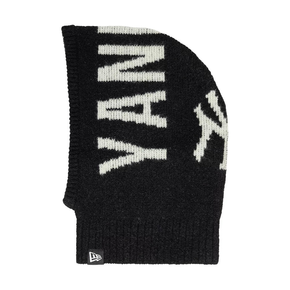 New Era New York Yankees MLB Script Black Balaclava Hat, side view showing the white Yankees script running vertically along the black knit fabric, with a NY logo near the top and the New Era flag logo on the ribbed hem.