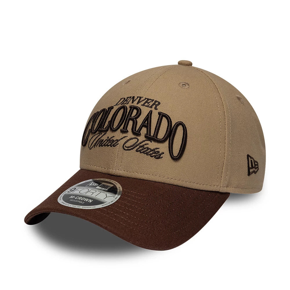 New Era Colorado Beige & Brown 9FORTY M-Crown Adjustable Cap, front view showing raised black embroidered Denver Colorado United States lettering on beige crown, brown curved visor with 9FORTY size sticker, New Era flag logo on the left side.