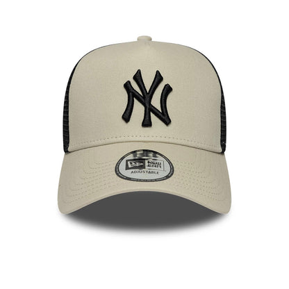 Pictured is this MLB League Essential New York Yankees 9FORTY A-Frame Trucker cap in light beige. 2
