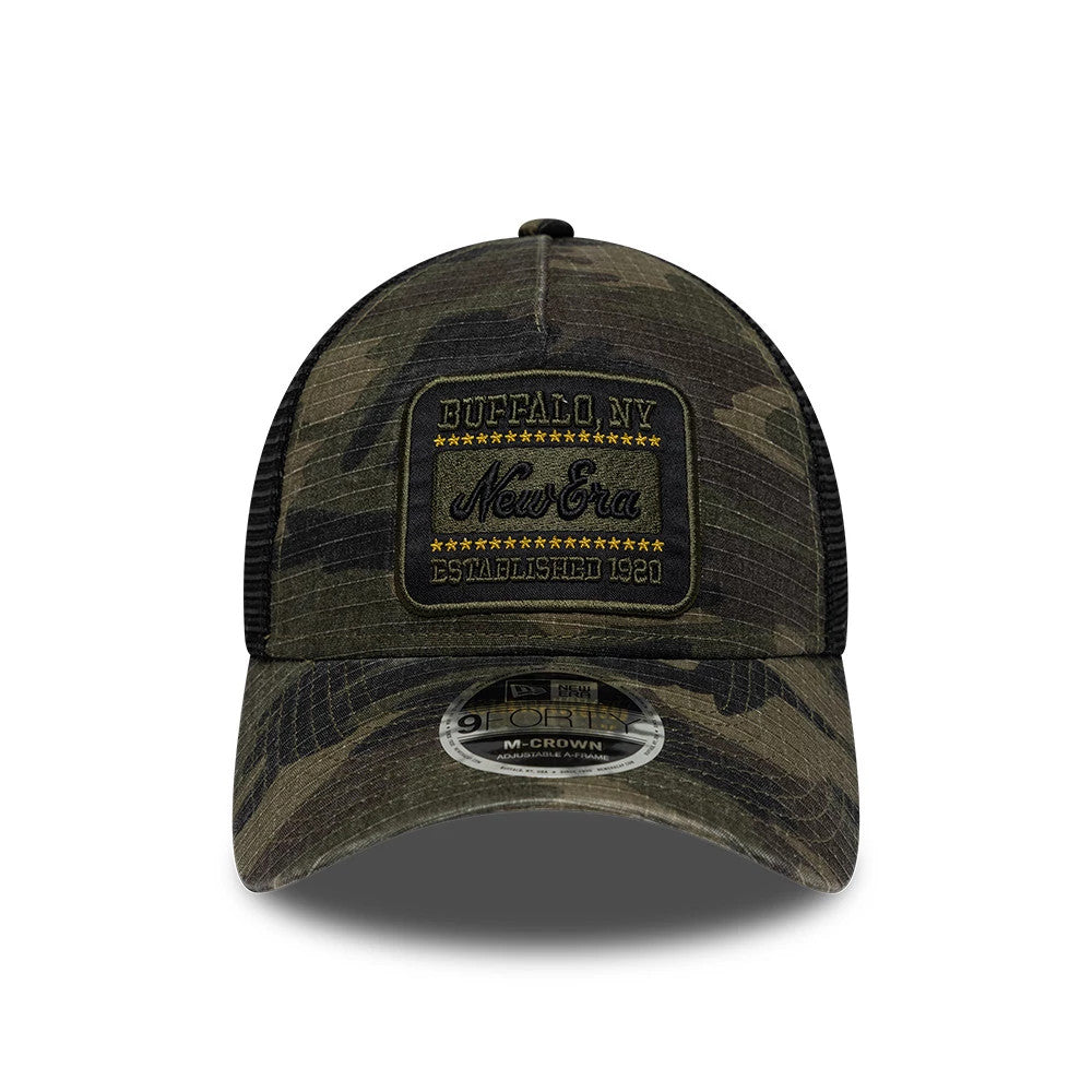 New Era Camo Woodland Camo 9FORTY M-Crown A-Frame Trucker Adjustable Cap, front view showing a black and gold embroidered patch with Buffalo, NY text on the camo front panel, with a grey mesh back and a 9FORTY size sticker on the camo visor.