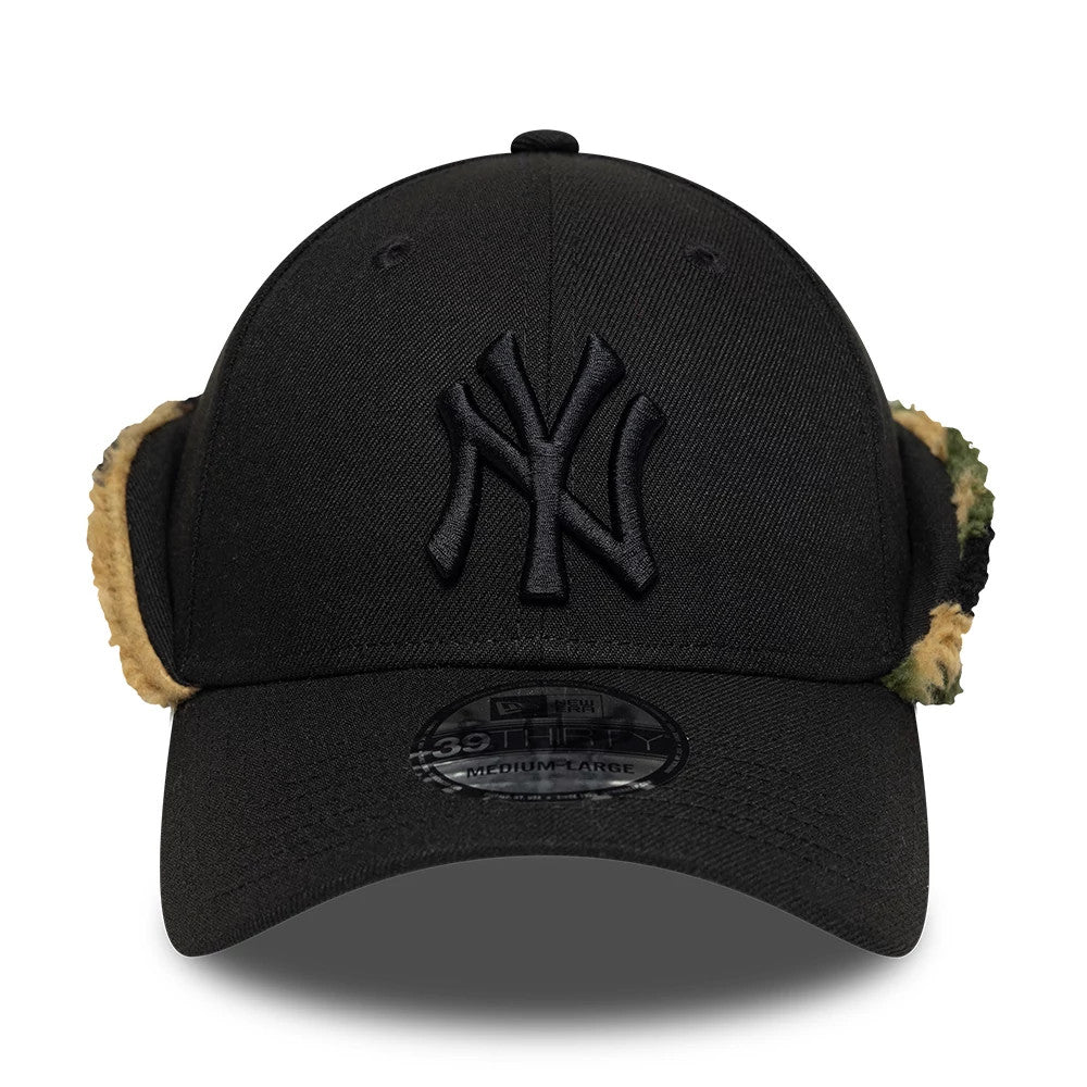 New York Yankees MLB Black New Era 39THIRTY Downflap Stretch Fit Cap, front view showing raised black NY logo embroidery on the front panel, black curved visor with 39THIRTY size sticker, and tan camouflage downflaps on the sides.