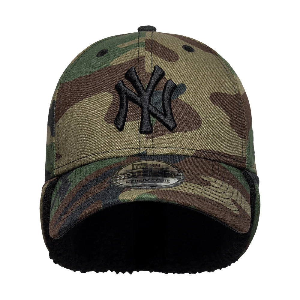 New York Yankees MLB Camo Black New Era 39THIRTY Downflap Stretch Fit Cap, front view showing the raised black NY logo embroidered on the camouflage front panels, with a 39THIRTY size sticker on the curved visor and earflaps beneath.