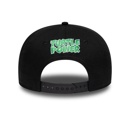 Youth Teenage Mutant Ninja Turtles Black New Era 9FIFTY Snapback Adjustable Cap, rear view showing the green embroidered Turtle Power text on the black structured crown, with an adjustable black snapback closure beneath.
