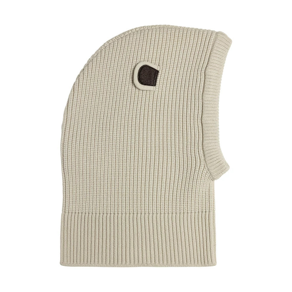 Child New Era Bear Light Beige Balaclava Hat, side view showing the ribbed knit texture and a small dark brown ear detail on the top side, with an extended ribbed band for added coverage and comfort.