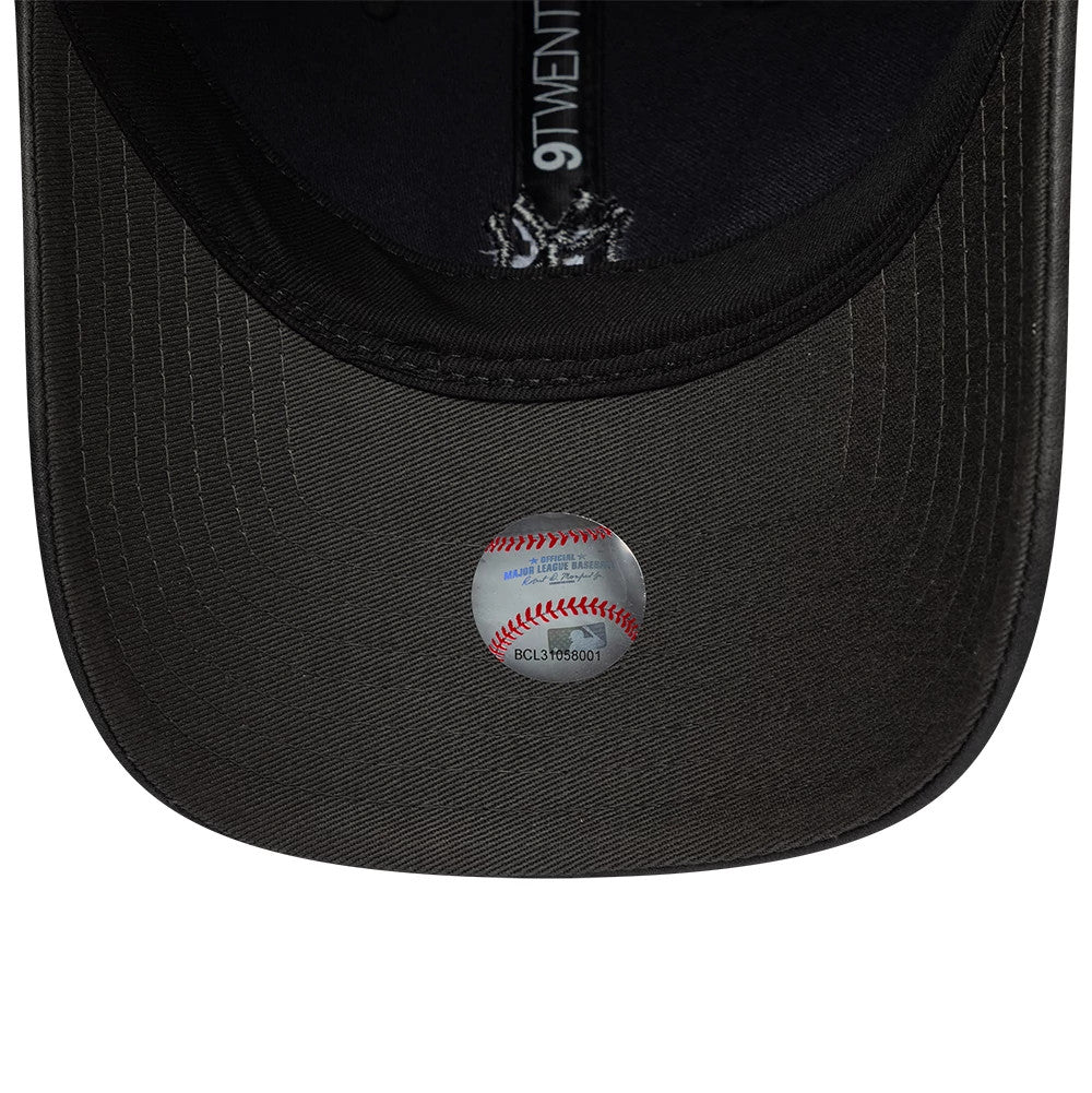 New York Yankees Womens MLB Washed PU Black New Era 9TWENTY Adjustable Cap, inside view showing the black taping with a white 9TWENTY logo, a curved black sweatband, and the underside of the washed black curved visor with a round baseball sticker.