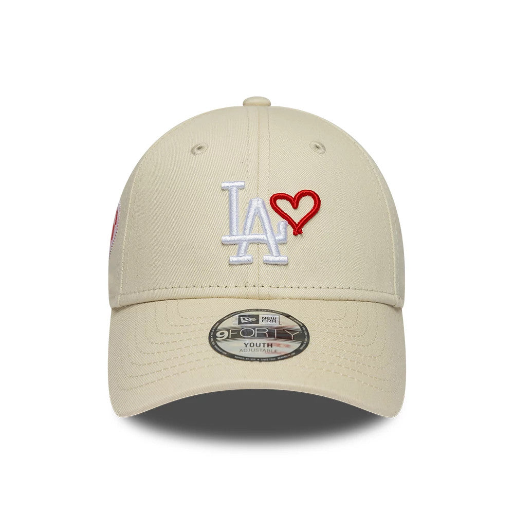 LA Dodgers Youth MLB Heart Icon Light Beige New Era 9FORTY Adjustable Cap, front view showing the white LA embroidered logo with a red heart on the structured light beige crown, complemented by a 9FORTY size sticker on the matching curved visor.