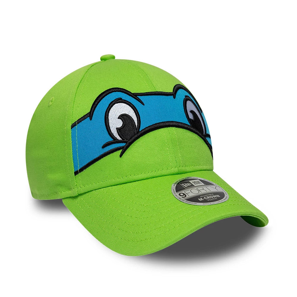 Youth TMNT Face Bright Green New Era 9FORTY M-Crown Adjustable Cap, three-quarter view showing the large embroidered Ninja Turtle eyes with a blue mask on the front panel, bright green curved visor and 9FORTY size sticker.