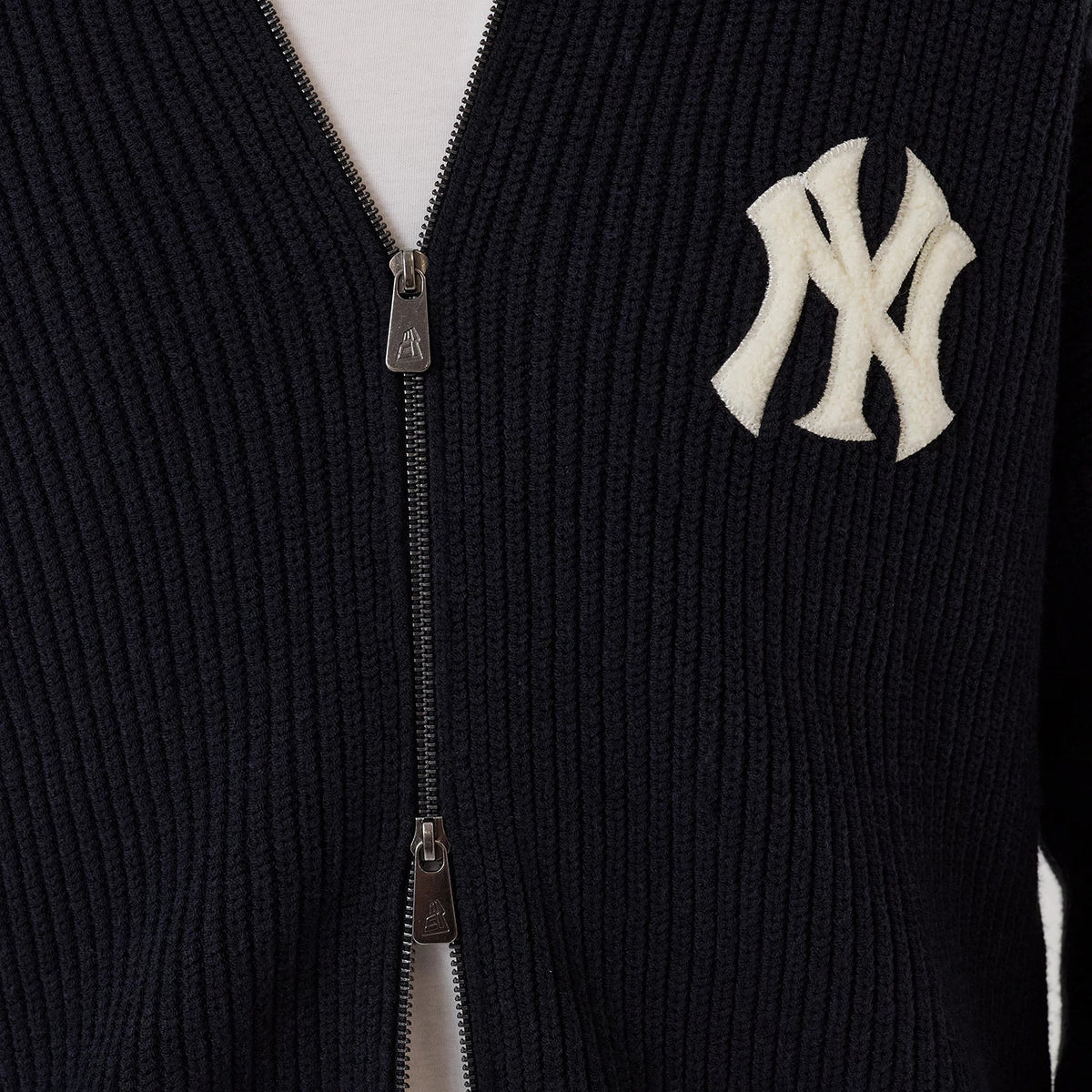 The model is wearing this MLB New York Yankees 2 Way Zip Cardigan in navy. 3
