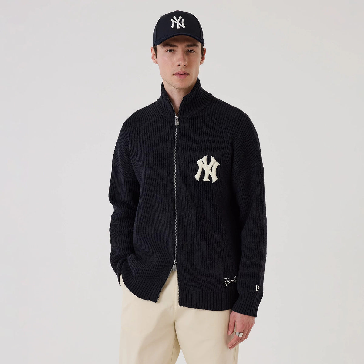 The model is wearing this MLB New York Yankees 2 Way Zip Cardigan in navy. 1