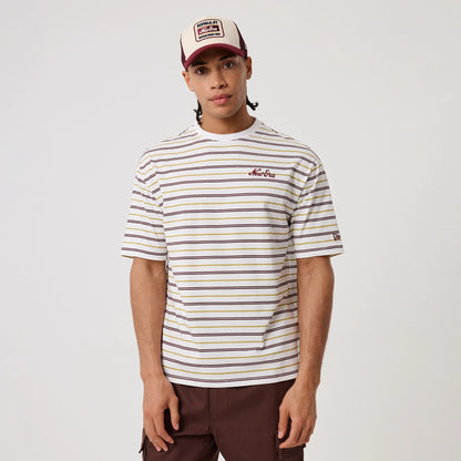 New Era Stripe White T-Shirt, front view on a model styled with a cap, showing horizontal stripes in brown, yellow, and purple, an embroidered New Era logo on the chest, and another embroidered logo on the left sleeve.