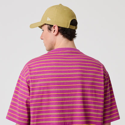 New Era Stripe Bright Purple T-Shirt, back view showing alternating yellow and pink horizontal stripes across the fabric, worn on-model with a beige cap featuring an embroidered New Era logo at the side.