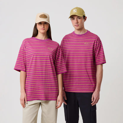 New Era Stripe Bright Purple T-Shirt, front view on models showing pink and yellow striped design, an embroidered New Era logo on the left chest, and short sleeves, with a casual fit styled with beige and khaki caps.