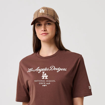 New Era LA Dodgers MLB Linear Brown T-Shirt, front view on-model with a matching checked cap, features the white embroidered Los Angeles Dodgers script and LA logo on the chest, while the New Era flag logo is printed on the sleeve.
