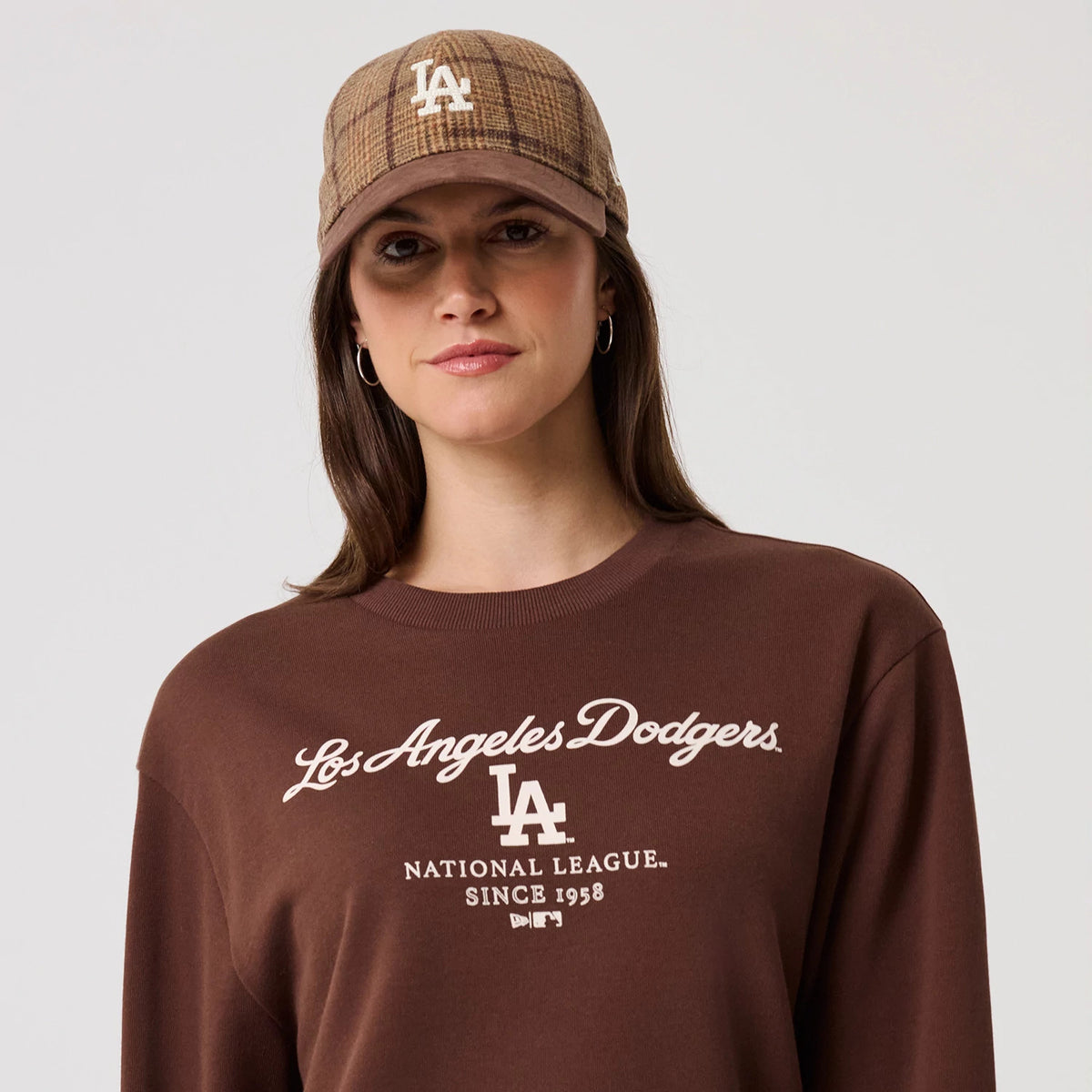The model is wearing this MLB Linear LA Dodgers Crew Neck Sweater in brown. 6