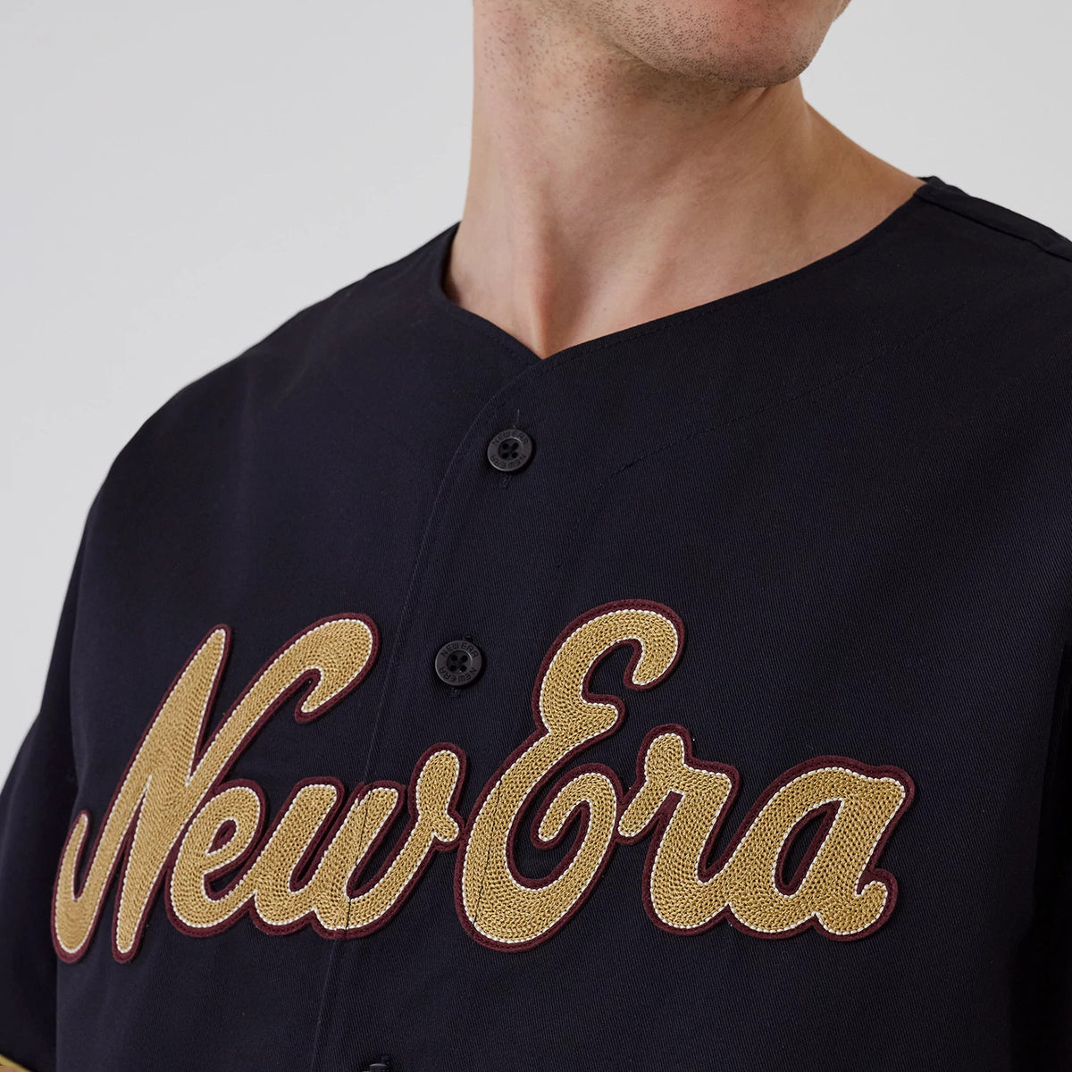 The model is wearing this New Era Straight Hem Jersey in navy. 4