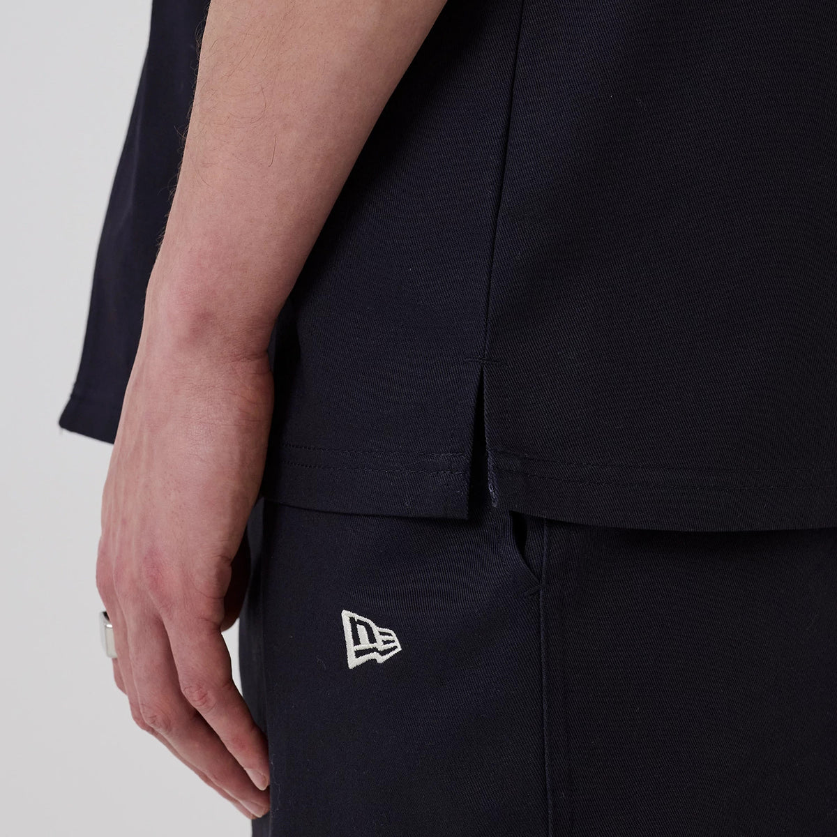 The model is wearing this New Era Straight Hem Jersey in navy. 6