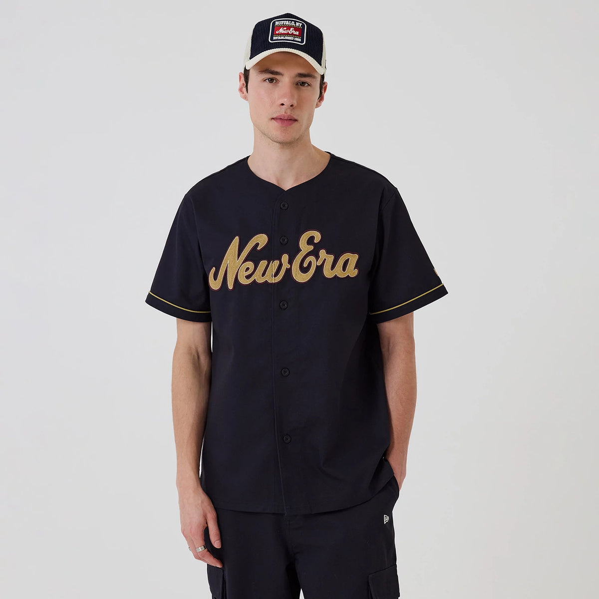 The model is wearing this New Era Straight Hem Jersey in navy. 1