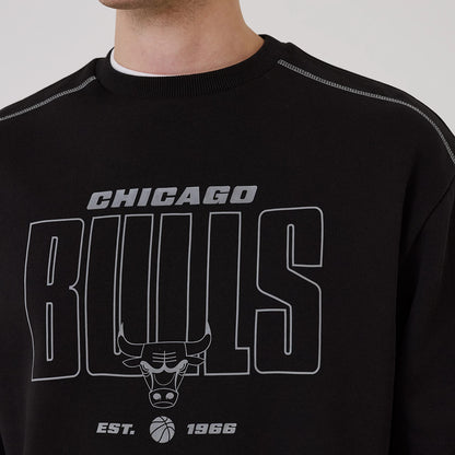 New Era Chicago Bulls NBA Graphic Black Crew Neck Sweater, front view on a model featuring large grey Chicago Bulls text and a bull head logo across the chest, with contrasting stitch details on the shoulders and a ribbed neck.