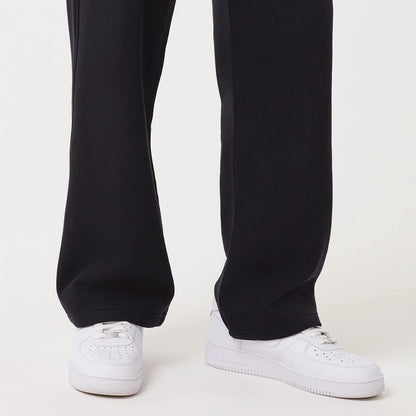 New Era Navy Straight Leg Joggers, close-up view showing the relaxed fit around the ankles, deep navy colour and the pairing with white trainers, highlighting the fabric texture and simple hem design.