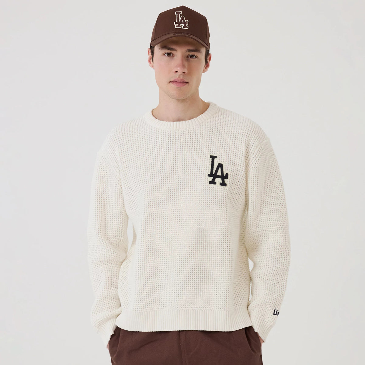 The model is wearing this MLB Waffle Knit LA Dodgers Crew Neck Sweater in open white. 1