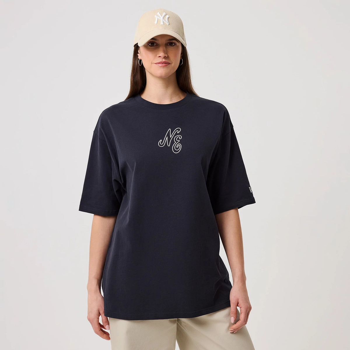 The model is wearing this New Era Crest Graphic Oversized T-Shirt in navy. 4