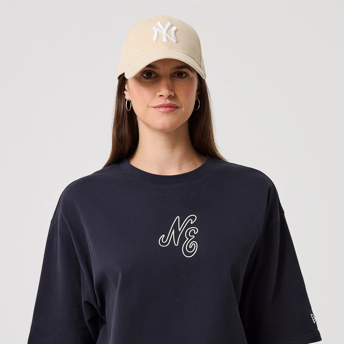 The model is wearing this New Era Crest Graphic Oversized T-Shirt in navy. 6