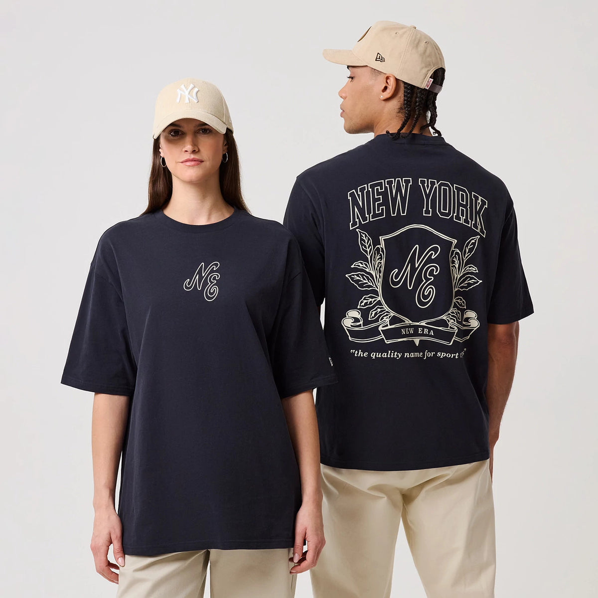 The model is wearing this New Era Crest Graphic Oversized T-Shirt in navy. 1