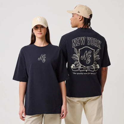The model is wearing this New Era Crest Graphic Oversized T-Shirt in navy. 1